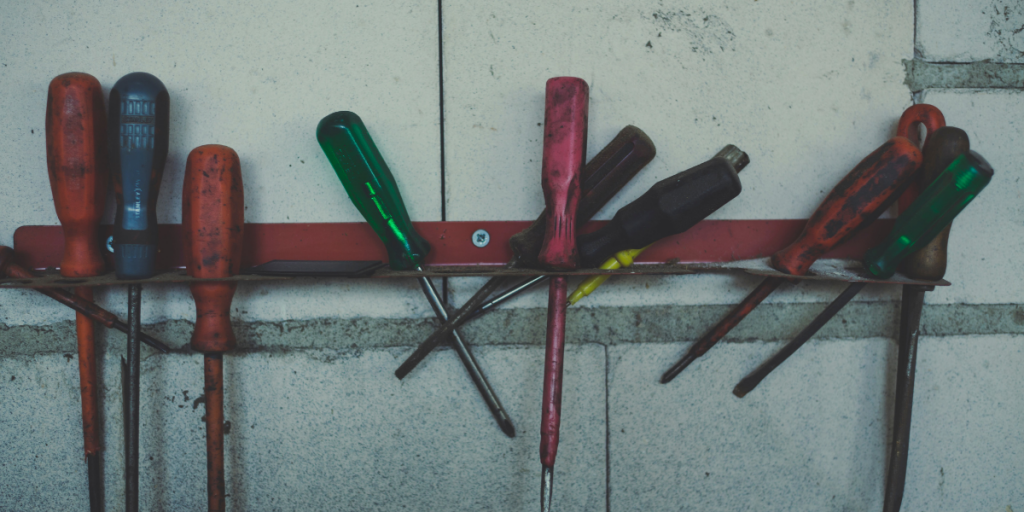 Tools hung up on a wall.