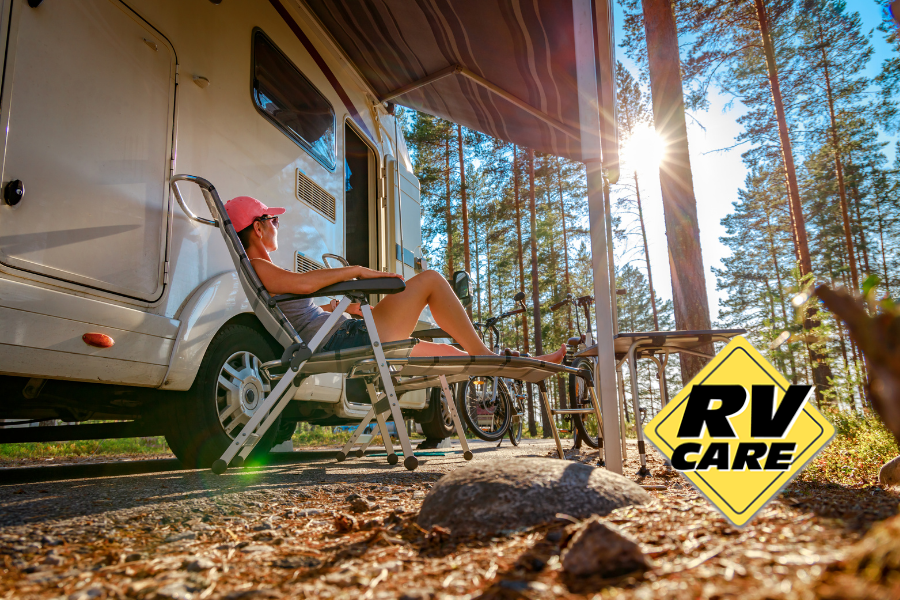 Camper lounging outside of RV in nature.