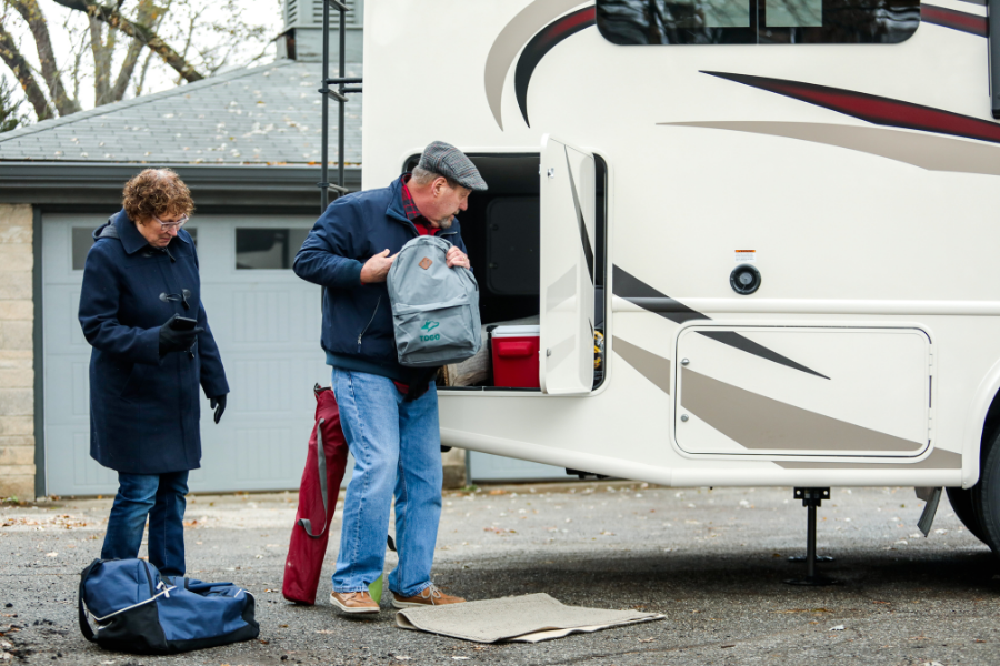 Couple packing their RV for a camping trip.