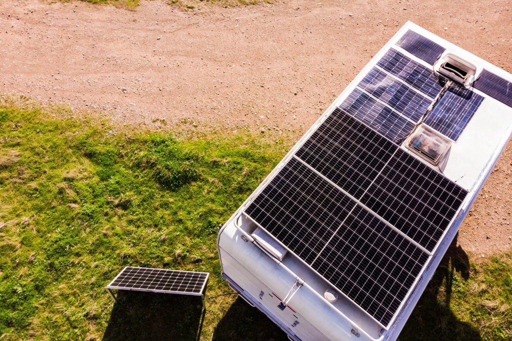 Travel trailer set up at a boondocking site with solar panels on the roof